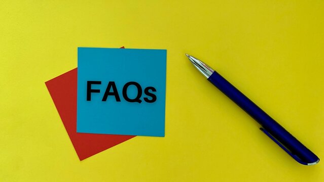 FAQs Text On Blue Post It Note With Pen And Yellow Background. Business Concept.