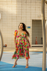She is posing in a floral dress at a water park