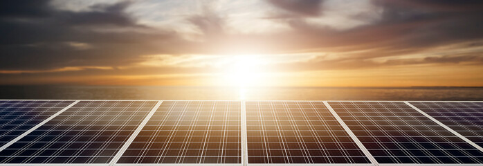 panoramic - solar panel at sunset in the sea