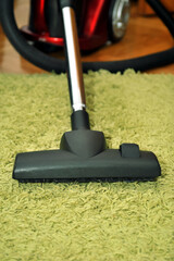 Dusty green carpet vacuuming