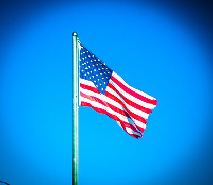 An American flag flies proudly in a clear winter sky in Jefferson, Ohio