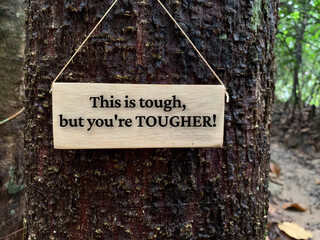 Motivational and inspirational quote - This is tough, but you are tougher. With trees and jungle background. Inspirational concept.