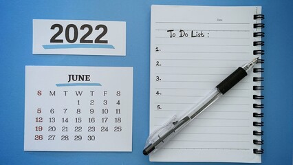 o do list text written on notepad with month of June 2022 calendar and pen background. 2022 new year concept.