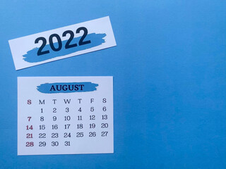 August 2022 white calendar with blue background. 2022 new year concept