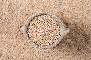close up of sesame seeds in jute bag background
