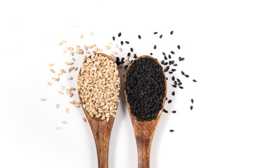 White sesame and black sesame seeds in spoon on white background