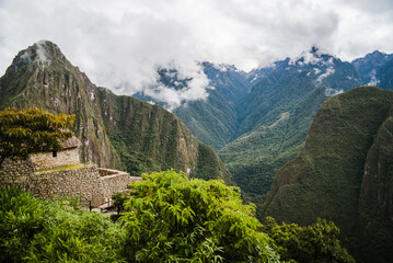Fototapeta na wymiar Mountain views of the Andes Mountains with Machu Picchu ruins in the foreground in Peru. 