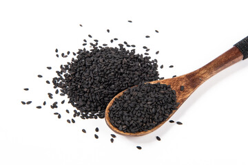 black sesame seeds in spoon on white background