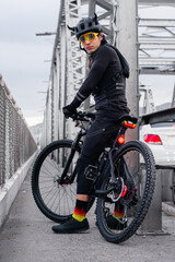 Fototapeta premium Cyclist with professional equipment riding a bike in the street