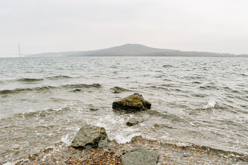 Nature, sights, architecture and life of the city of Vladivostok. Large stones on the seashore