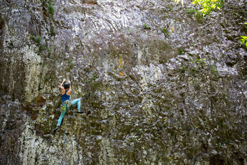Fototapeta premium People climbing on a beautiful basaltic cliff in Reunion island