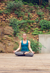 Finding strength from within. Shot of a young woman practicing yoga outdoors.