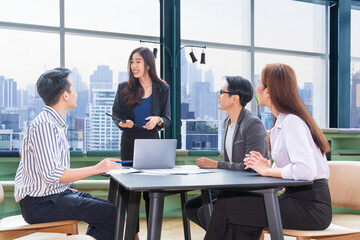 Team of young Asian entrepreneur have small team meeting for upcoming project for marketing and sale management with skyscraper view for business startup and education concept