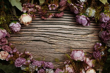 Frame of flowers with wooden banner for text on wooden background