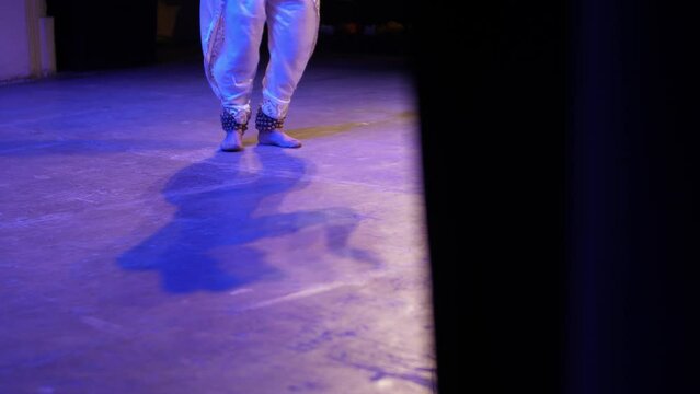 Dancing male legs. A man performs an Indian dance.