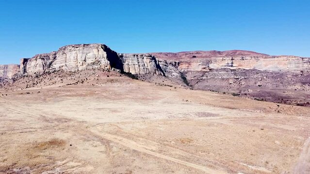 Aerial drone shot ascending up revealing the beautiful sandstone mountains of the Drakensberg, the remote area filled with amazing scenery and picturesque landscapes, KwaZulu Natal, South Africa