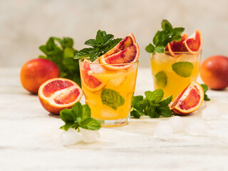 Fresh orange juice in a glass with splashes and drops. Summer refreshing and healthy dessert.