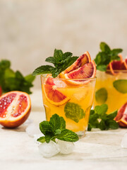 Fresh orange juice in a glass with splashes and drops. Summer refreshing and healthy dessert.