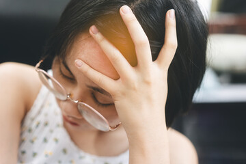 Young adult asian woman headache and depression stay alone on day.