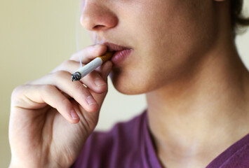 How to quit now.... Closeup of a person taking a drag from a cigarette.