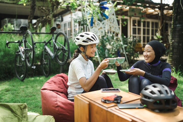 muslim road bike cyclist sitting in a coffee shop having a break