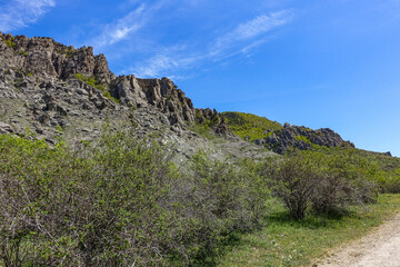 Fototapeta na wymiar Ancient limestone high mountains in the air haze. The Valley of Ghosts. Demerji. May 2021 . Crimea. Russia
