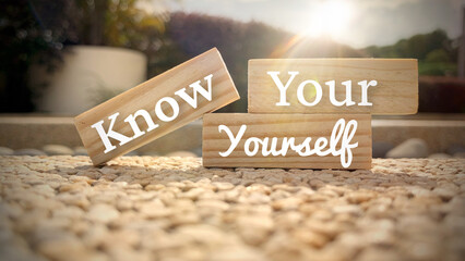 Know your yourself text on wooden blocks with bright shining sun. Motivational concept.