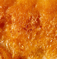 Golden crust of puff pastry as a background.