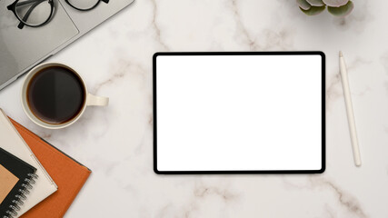 Modern minimal working space with tablet touchpad on white marble background.