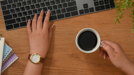 Female officer working on computer, typing on computer keyboard
