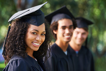 Bright young grads. Portrait of a diverse group of students on graduation day.