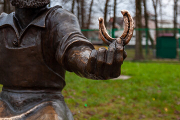 Fragment of a statue of a blacksmith holding a horseshoe