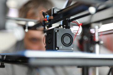 Fototapeta na wymiar Young student engineer use 3d printer. Prototyping classes and new technology concept.