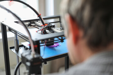 Young student engineer use 3d printer. Prototyping classes and new technology concept.