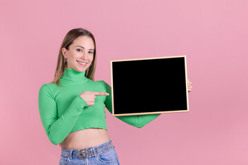 Beautiful woman holding a blank black chalkboard