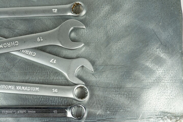 metal keys isolated on metallic gray background. copy space