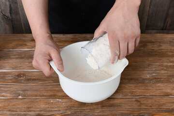 A man prepares dough