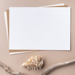 Minimal paper card mockup on beige background with dry branches and seashell