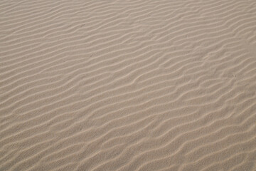 Fototapeta na wymiar sand texture wind wave water on sandy sea beach background natural