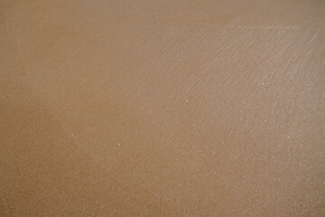 Fototapeta na wymiar brown sandy beach wallpaper of natural sand background