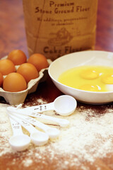 Time to bake something tasty. Shot of a variety of ingredients and measuring implements on a wooden table.