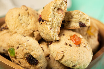 Freshly baked soft oatmeal cookies with raisins, candied fruits, flax and sesame seeds and walnuts close-up