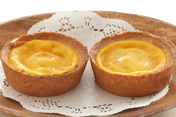 Asian sweet dessert, egg tart on wooden plate with copy space