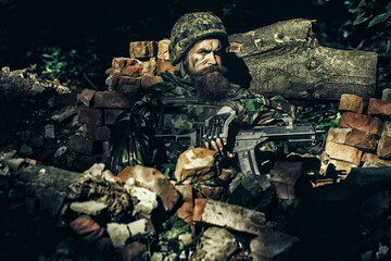 Military operation. Shooting with assault rifle and machine gun, attacking enemy. Military photo,...