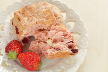 Strawberry scone with berries on side for breakfast image