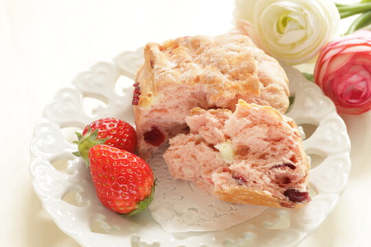 Strawberry scone with berries on side for breakfast image