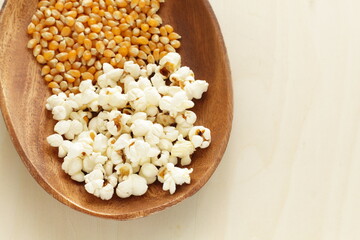 dried corn on wooden plate for cooking popcorn ingredient