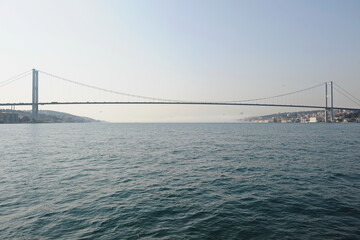 Fototapeta na wymiar Istanbul / Turkey - 02.28.2017 : Coastal zone and architecture of the Bosphorus Strait. A bridge connecting Europe and Asia.