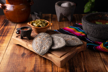 Tlacoyos. Mexican pre hispanic dish made of blue corn flour patty filled with refried beans. Popular street food in Mexico.