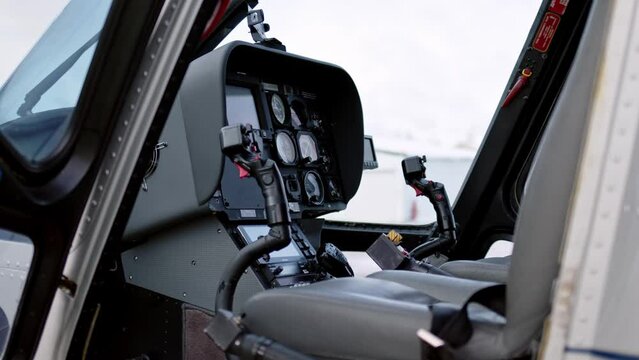 view of pilot cabin and stick joystick of civilian business helicopter, cockpit is inside. Aircraft instrument panel, focus on helicopter control stick.
